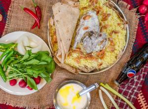 a table with a plate of food and a plate of vegetables at L goats house in Wadi Musa +41 photos