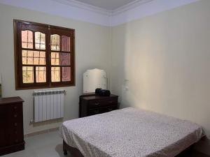 a bedroom with a bed and a window at L goats house in Wadi Musa