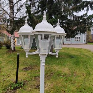 a white street light with snow on top of it at Villa Hakala in Utajärvi