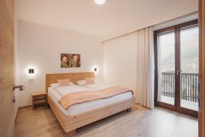Postel nebo postele na pokoji v ubytování Residence Karpoforus