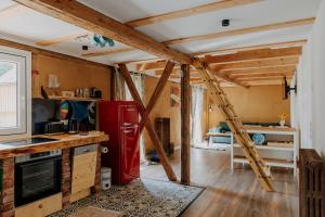 a kitchen with a red refrigerator and wooden beams at Ferienwohnung Linda in Ilmenau
