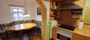 a small kitchen with a table and a counter top at Ferienwohnung Leon in Heldburg