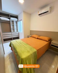 a bedroom with a bed with an orange bedspread at 01 - Saint Marie Beach House in Conde