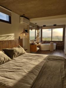 a bedroom with a large bed and a bath tub at La Singladura in La Población