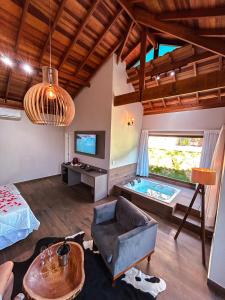 Ένα ή περισσότερα κρεβάτια σε δωμάτιο στο Hotel Chalés Capitanias