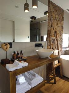 a bathroom with a sink and a counter with towels at La Singladura in La Población +47 photos