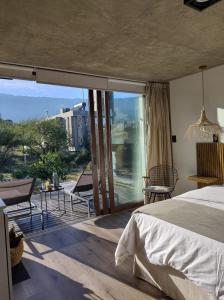 a bedroom with a bed and a balcony with a view at La Singladura in La Población