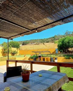 a patio with a table and a view of a field at El Pico de Aroche in Aroche
