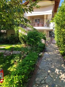 a garden with a bench in front of a building at SOLMAR HOUSE in Flogita