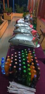 a row of bottles lined up on a table at Juniper Park Resort in Nyahururu +43 photos