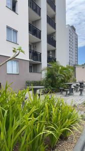 a row of benches in front of a building at Apartamento novo perto da praia e Beto Carrero in Piçarras +20 photos