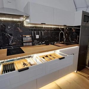 a kitchen with white cabinets and a counter top at Glamping Casas Eco Natura in Cabrais