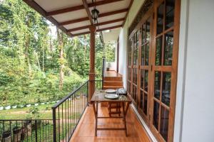 a screened porch with a table on it at Teyra Lodge in Galle