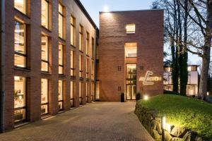 a brick building with a pathway in front of it at Arcadeon in Hagen