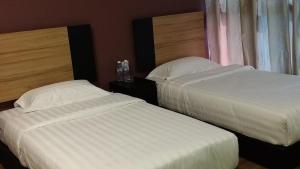 Letto o letti in una camera di Amigo Hotel