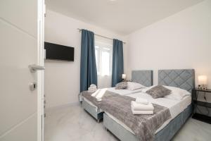 En eller flere senge i et værelse på Apartments Filipo