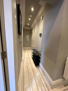 a hallway with a long hallway with wooden floors at Stunning 2-bedroom Apartment in Manchester Centre in Manchester