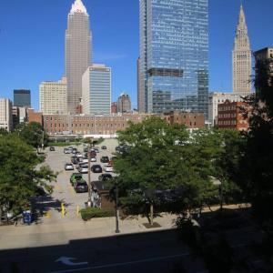 a city skyline with cars parked in a parking lot at Downtown Cleveland Historic District in Cleveland