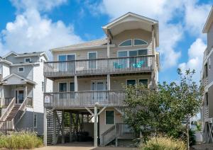 a large apartment building with a balcony at Shell Town in Nags Head