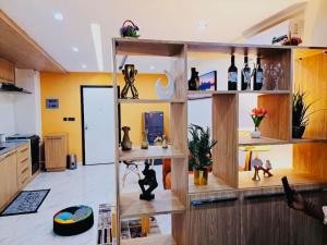 a room with wooden shelves with bottles of wine at Appart haut standing Riviera in Abidjan