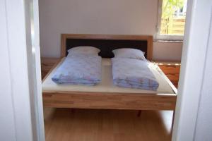 a bed with two pillows on it in a room at Carodorfblick in Carolinensiel