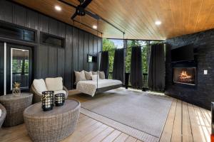 a living room with a fireplace and a couch at Enchanting Escape for Two in Broken Bow