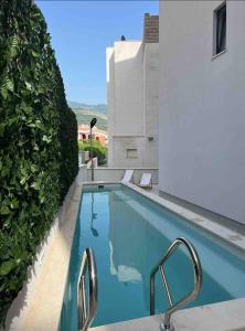 a swimming pool on the side of a building at Horizon-Two Bedroom Apartment Partial Sea View Charlene in Becici