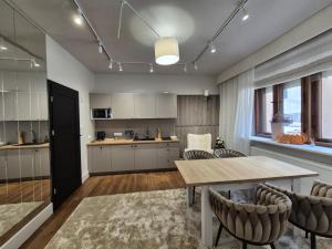 a kitchen and dining room with a table and chairs at Piernikarska 4 łazienki in Toruń +70 photos