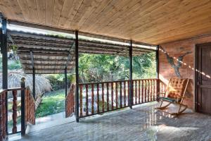 a screened in porch with a chair on it at Event House Kona in Asuretʼi +3 photos
