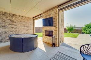 a patio with a stone fireplace and a table at Spacious Lubbock Home with Private Pool and Yard! in Lubbock