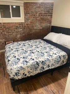 a bedroom with a bed with a blue and white blanket at Belle Isle Retreat in Detroit