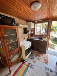 a small kitchen with a stove and a sink at chalet chenal in Hauru