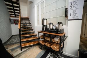 a coffee shop with a staircase in a room at Hotel San Luis Mongui in Monguí