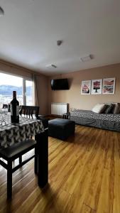 a large living room with a table and a couch at Robinson Alojamientos - Edificio María Gricelda in Ushuaia