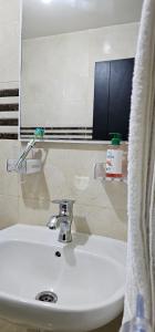 a bathroom sink with a mirror and a toothbrush on it at Diar Kamiliya Meknès in Meknès +16 photos