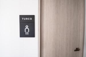 a door with a sign on it next to a person at Apartamentos Luxury Hotel Porto Horizonte - AR Rentals in Gaira