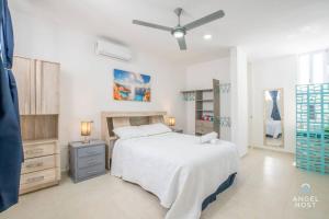 una camera da letto con un letto e un ventilatore a soffitto di Penthouse Apartments Private Roof Pool 200m to Beach a Chicxulub Altre 46 foto