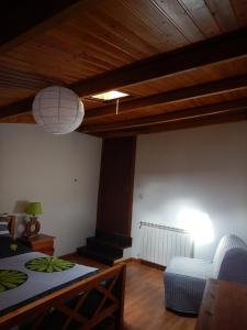 a living room with a bed and a couch at Casa da Pracica, Serapicos in Vale de Frades