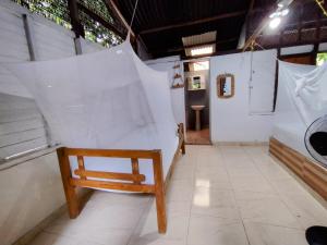 a wooden chair in a room with white walls at Eco Hotel Campo Verde in Isla Grande