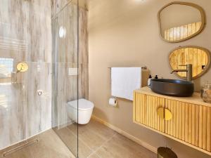 a bathroom with a toilet and a sink and a shower at Newly renovated, City Central, Spacious and Family friendly in Cape Town +22 photos