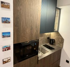 a small kitchen with a sink and a stove at Studio 12 Prishtina in Pristina +11 photos