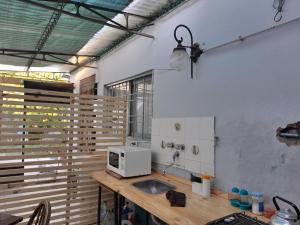 a kitchen with a sink and a microwave on a counter at El cerezo in Tandil