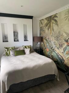 a bedroom with a large bed with a wall mural at Villa Maolo 2 in Roquebrune-sur-Argens +35 photos