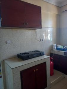 a kitchen with a stove top on a counter at FLORENCE APARTMENTS A in Mtwapa