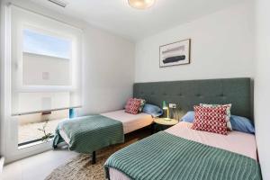 a bedroom with two beds and a window at Turquesa del Mar - Charming Ground-Floor Spanish Apartment with Large Sunny Terrace in Orihuela Costa +66 photos