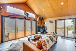 a living room with a couch and large windows at Colorado River Getaway in Parachute Dogs Welcome! in Parachute