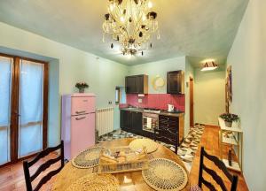 a kitchen with a wooden table and a pink refrigerator at Cavour 33 in Vitorchiano