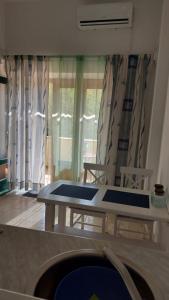 a room with a table and chairs and curtains at Apartment Brane in Bol