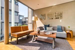 a living room with a couch and a table at AR 218 Hotel by ULIV in Mexico City