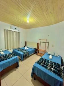a room with three beds in a room at Casa por temporada Bhs in Barreirinhas +18 photos